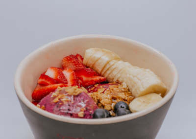 A bowl with banana, blueberrys ,oatmeal and strawberries on it