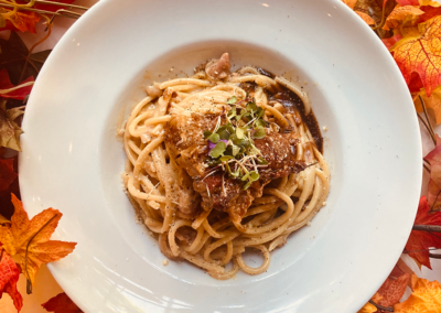 A plate of spaghetti with sauce and cheese on it, from the allegro restaurant"