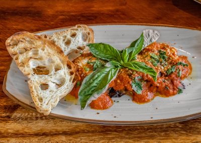 A plate of pasta and bread from a restaurant called al dente