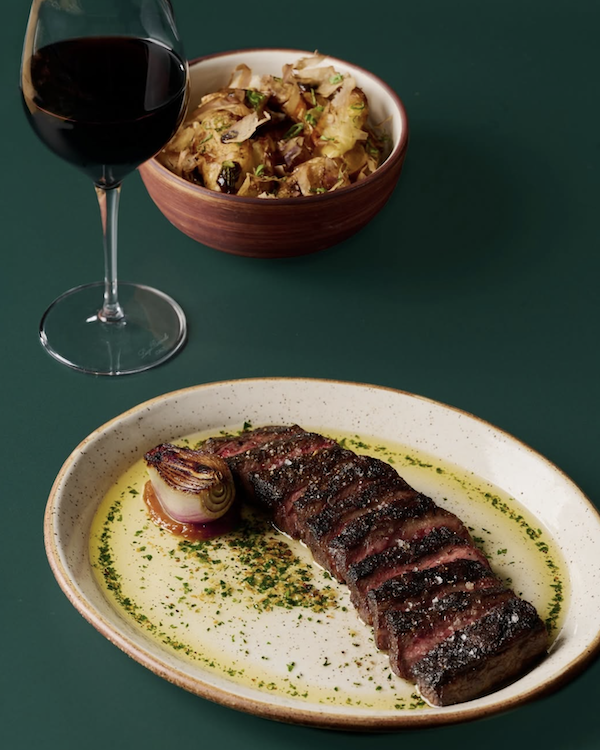 Modern steakhouse dining with sunset views at Ember & Rye Carlsbad