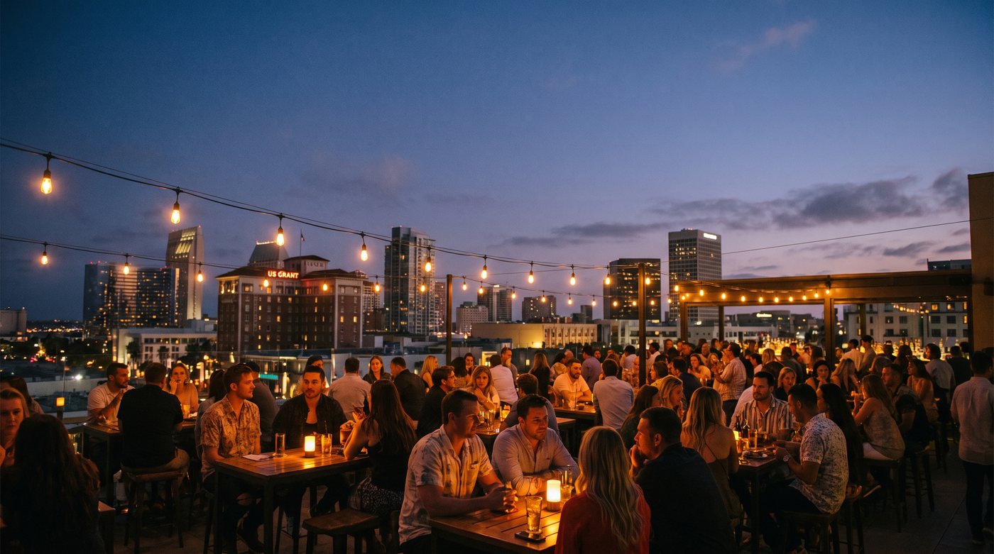 Full rooftop bar at dusk overlooking the San Diego skyline